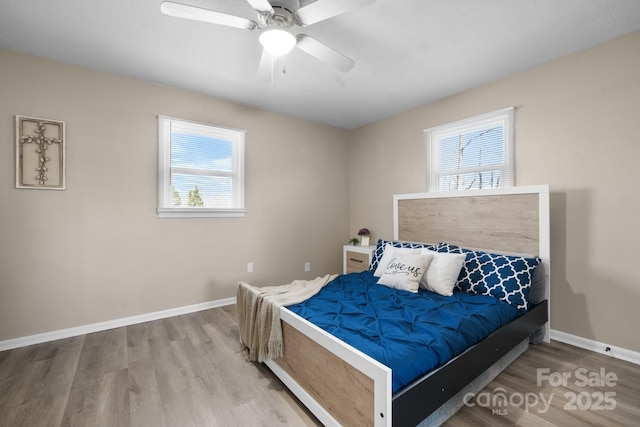 bedroom with ceiling fan and wood-type flooring