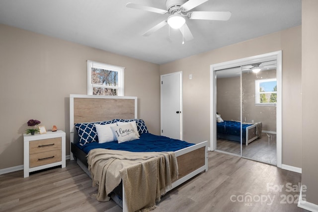 bedroom featuring a closet, light hardwood / wood-style flooring, and ceiling fan