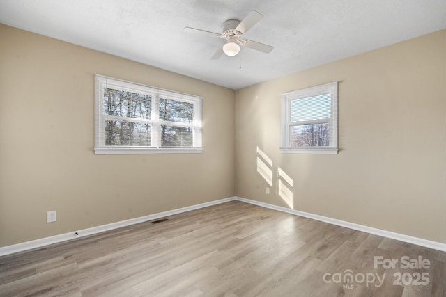 unfurnished room featuring light hardwood / wood-style floors and ceiling fan