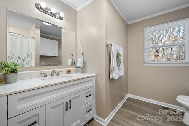 bathroom featuring toilet, crown molding, hardwood / wood-style floors, and vanity