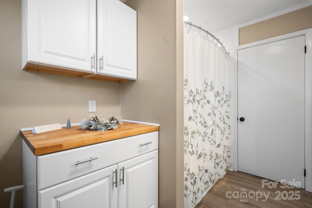 bathroom with hardwood / wood-style flooring