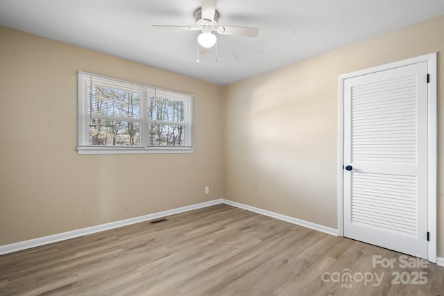 spare room with ceiling fan and light hardwood / wood-style floors