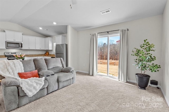 living room featuring vaulted ceiling, ceiling fan, and light carpet