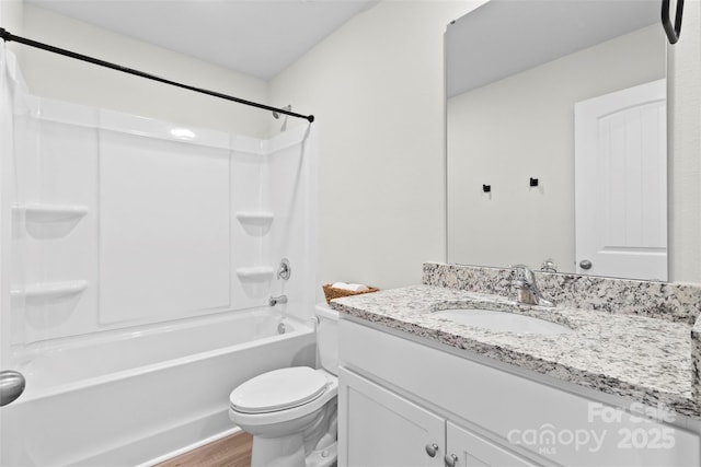 full bathroom with hardwood / wood-style floors, toilet, bathtub / shower combination, and vanity