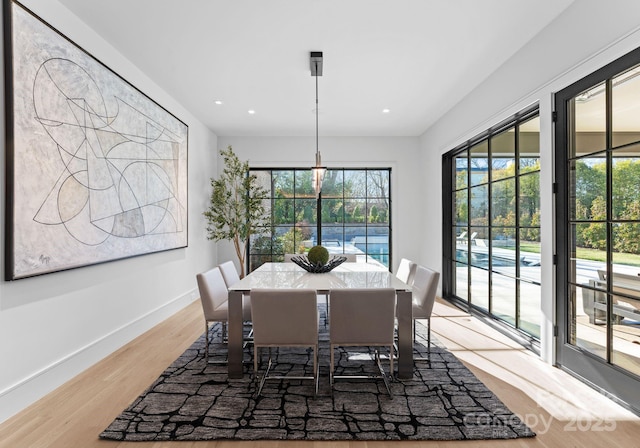 dining space featuring light wood-style floors, recessed lighting, and baseboards