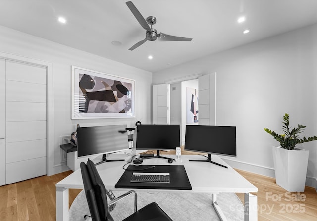 office featuring light wood-style flooring, a ceiling fan, and recessed lighting