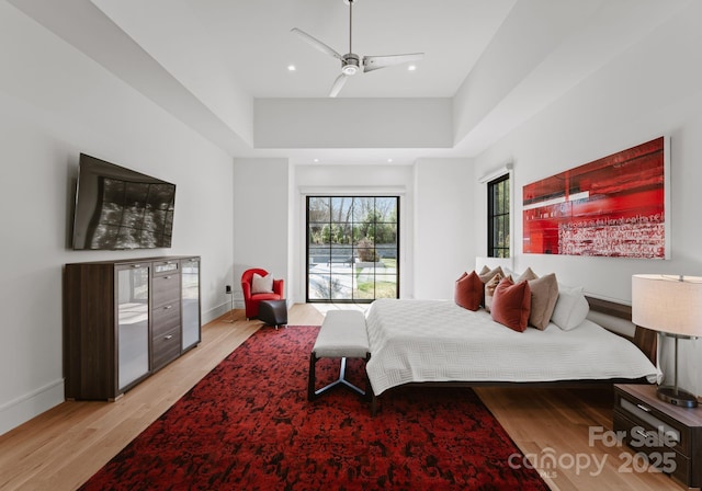 bedroom with light wood finished floors, recessed lighting, a ceiling fan, and baseboards