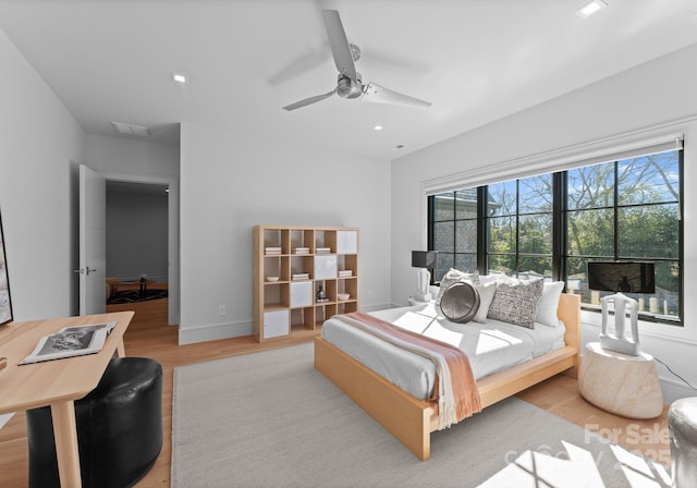 bedroom with baseboards, ceiling fan, light wood finished floors, and recessed lighting