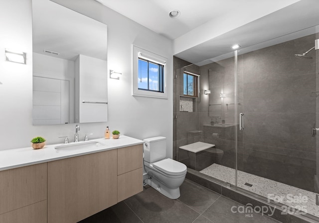 full bathroom featuring visible vents, toilet, a stall shower, vanity, and tile patterned floors