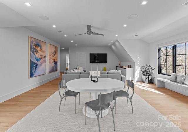 dining area featuring lofted ceiling, light wood finished floors, baseboards, and recessed lighting