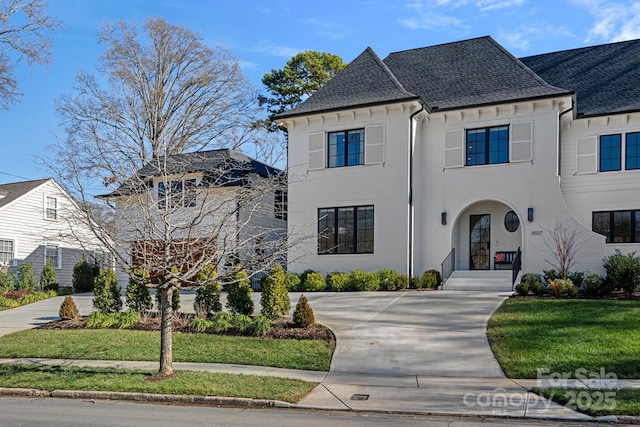 french country style house with a front yard