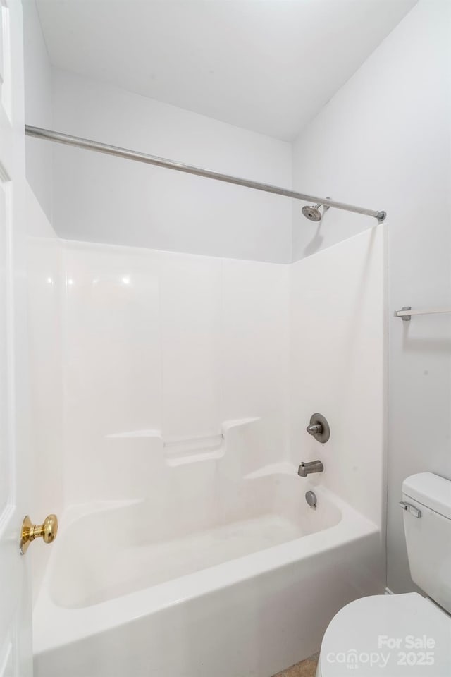 bathroom featuring toilet and bathing tub / shower combination