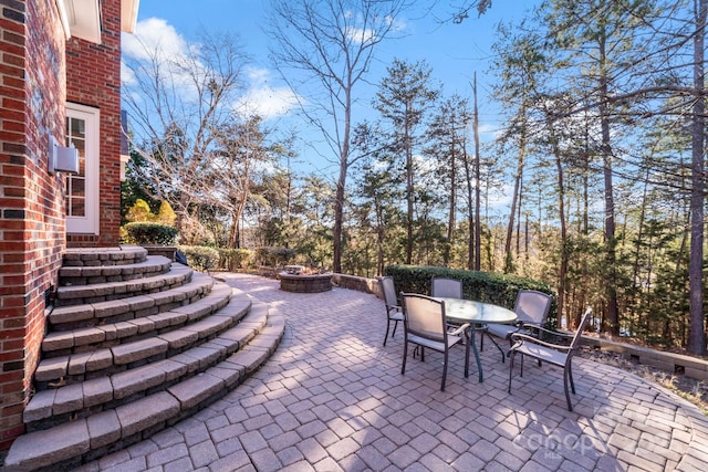 view of patio with an outdoor fire pit