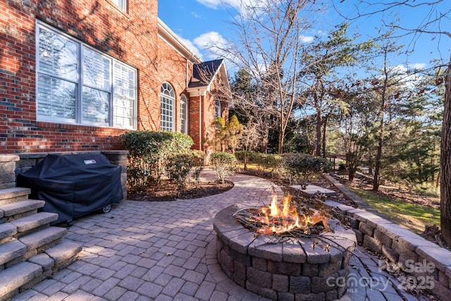 view of patio featuring a grill and a fire pit