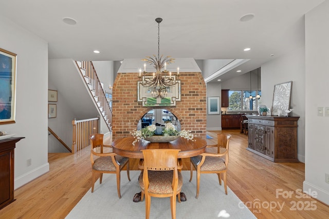 dining room with an inviting chandelier and light hardwood / wood-style flooring