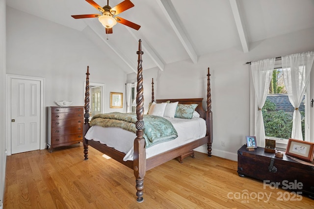 bedroom featuring ceiling fan, light hardwood / wood-style floors, high vaulted ceiling, and beamed ceiling