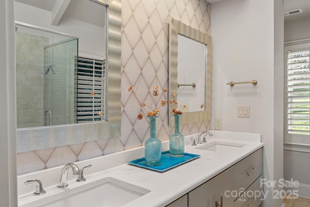 bathroom with vanity, a wealth of natural light, and a shower with door