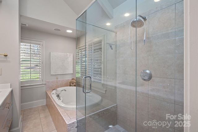 bathroom featuring plus walk in shower, tile patterned flooring, lofted ceiling, and vanity