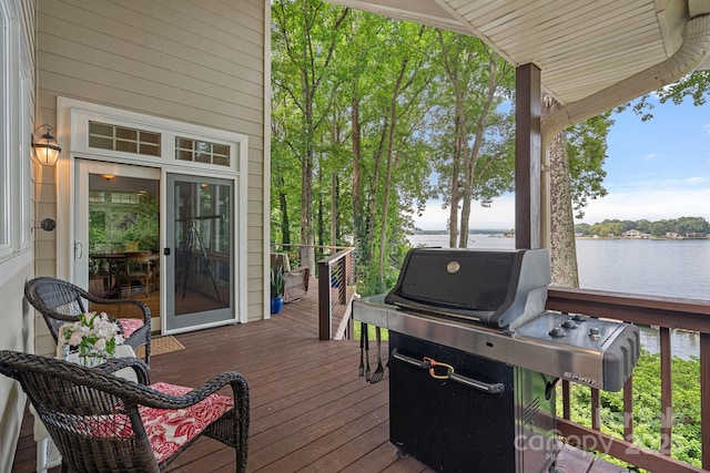 deck with a water view and grilling area