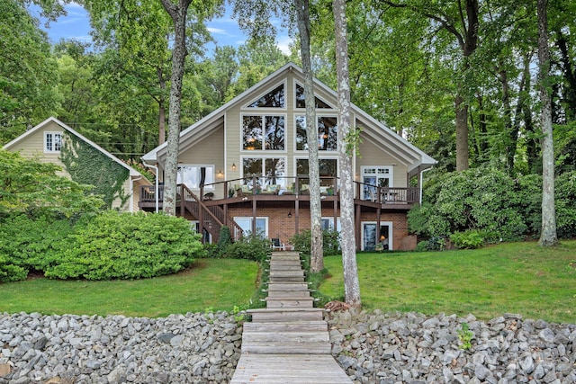 rear view of property with a lawn and a deck