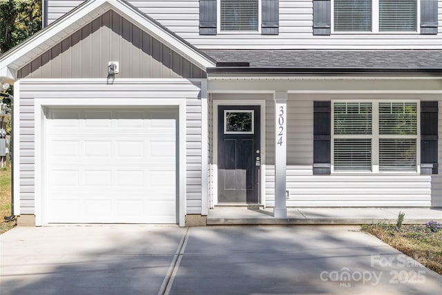 doorway to property featuring a garage and a porch