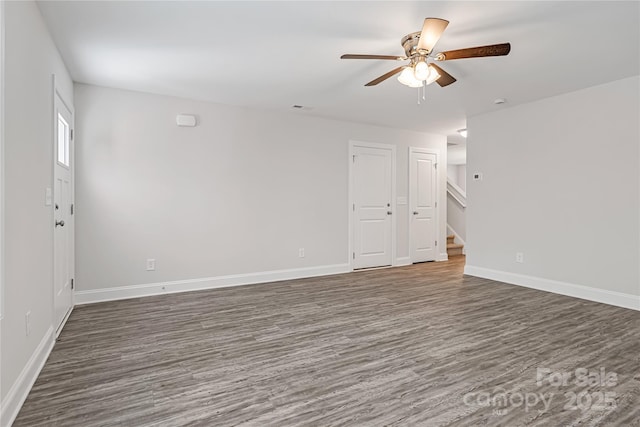 unfurnished room featuring ceiling fan and dark hardwood / wood-style floors