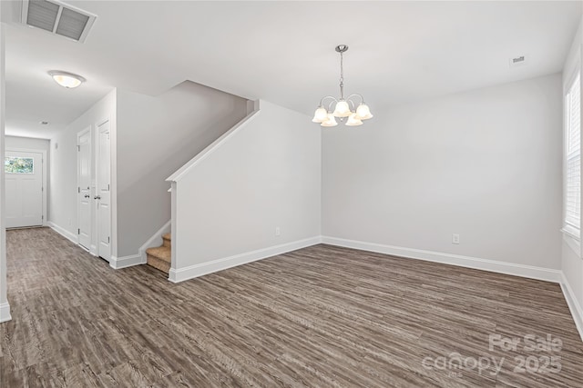 interior space with dark hardwood / wood-style flooring and a notable chandelier