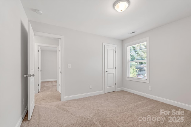 unfurnished bedroom with light colored carpet