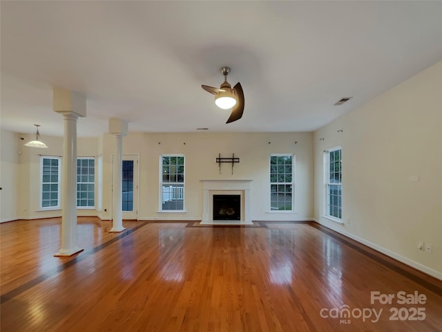 unfurnished living room with ceiling fan and hardwood / wood-style flooring