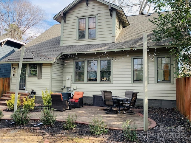 back of house with an outdoor living space and a patio