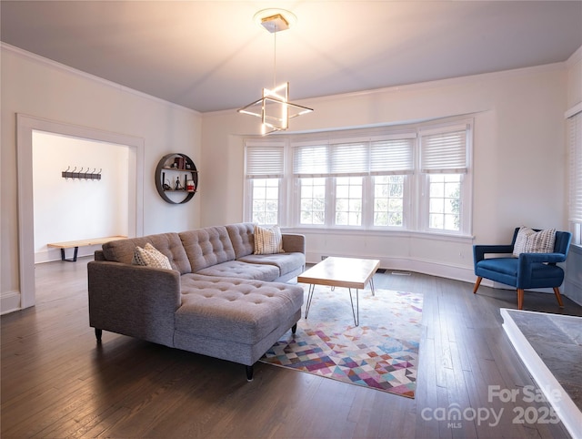 living room featuring ornamental molding and dark hardwood / wood-style floors