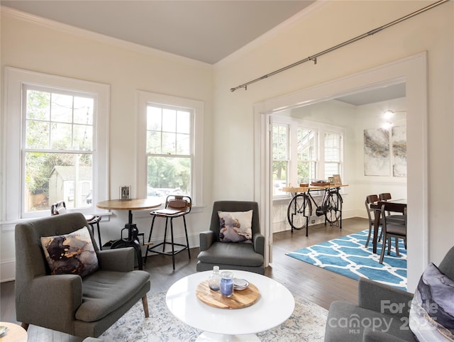 sitting room with crown molding and hardwood / wood-style flooring