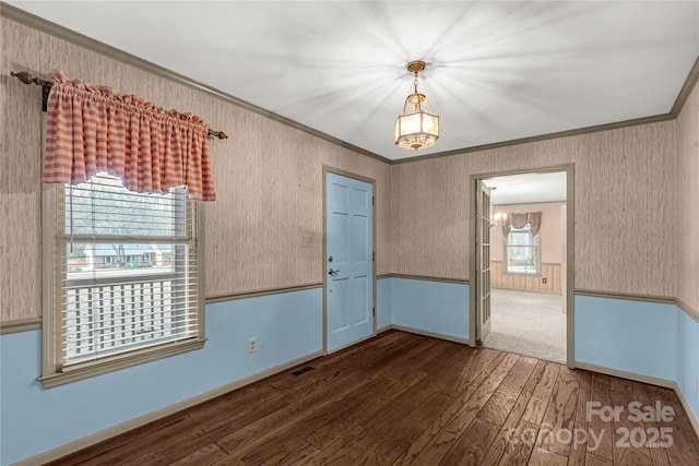 unfurnished room featuring ornamental molding and dark hardwood / wood-style floors