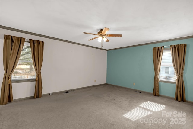 carpeted empty room with crown molding and ceiling fan