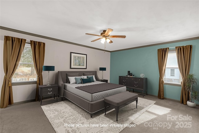 bedroom with ceiling fan, ornamental molding, and carpet flooring