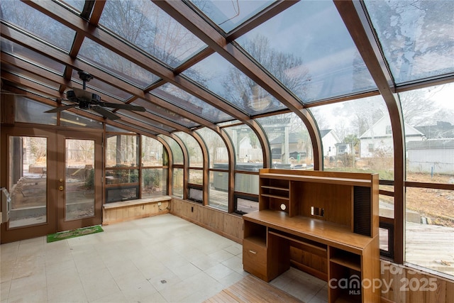 unfurnished sunroom featuring ceiling fan