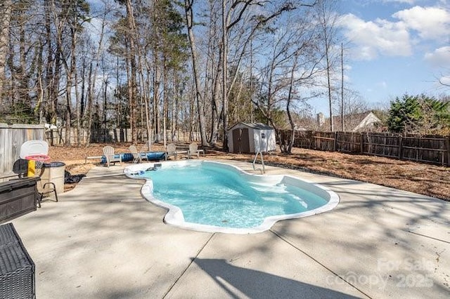 view of pool featuring a shed and a patio