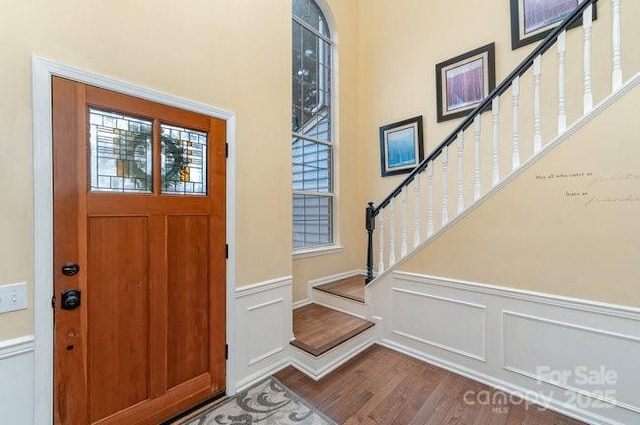 entrance foyer with hardwood / wood-style floors and a healthy amount of sunlight