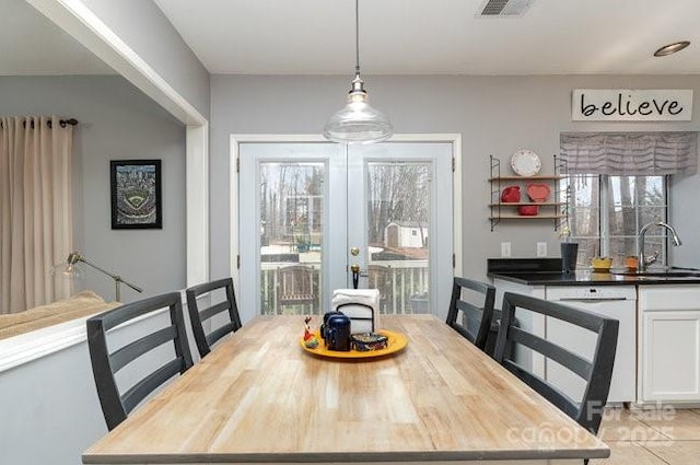 dining area with french doors and sink