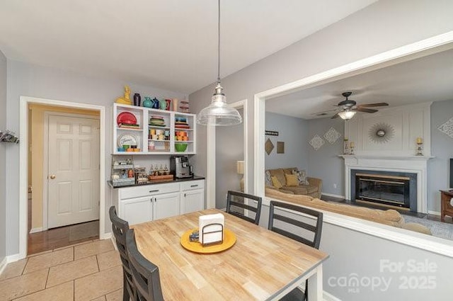 tiled dining room featuring ceiling fan