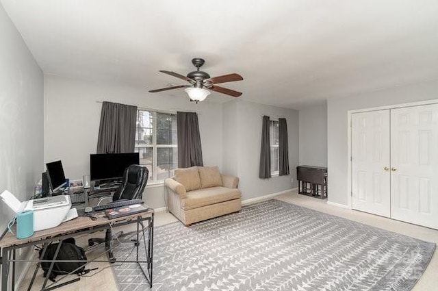 office with light carpet and ceiling fan