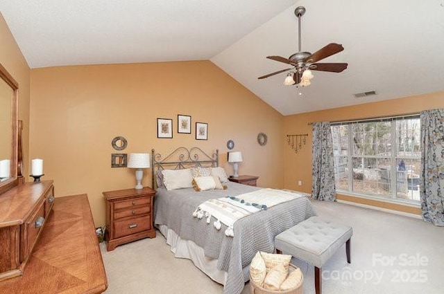 bedroom featuring vaulted ceiling, light colored carpet, and ceiling fan