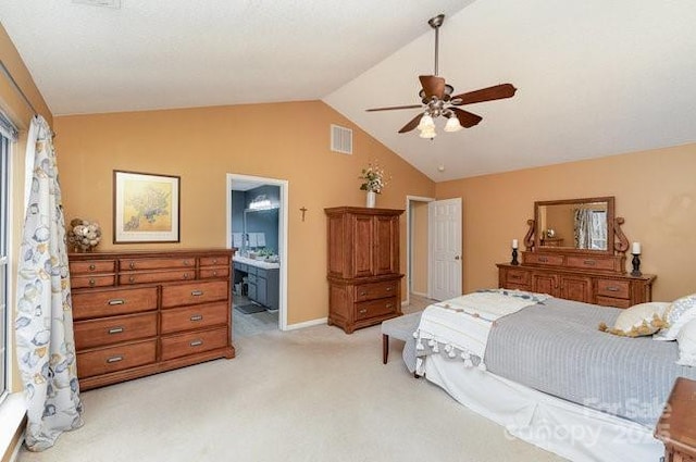 carpeted bedroom featuring lofted ceiling, ensuite bath, and ceiling fan