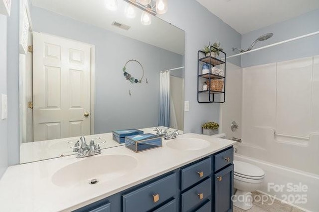 full bathroom with vanity, shower / bath combo with shower curtain, and toilet