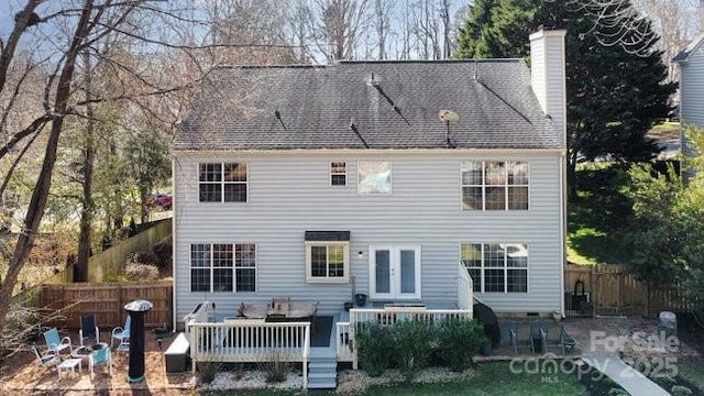 rear view of property featuring a wooden deck