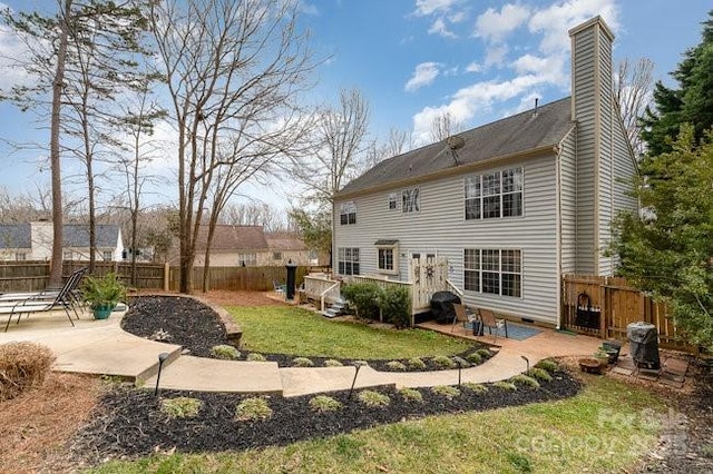 rear view of house with a patio and a yard