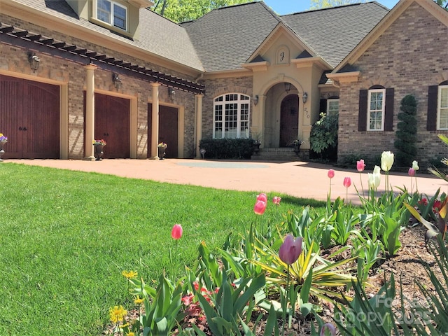 view of front of home with a front lawn and a garage