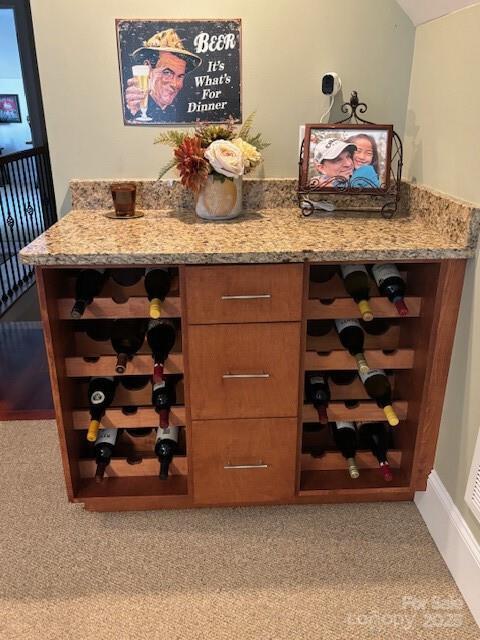 bar with light colored carpet and light stone counters