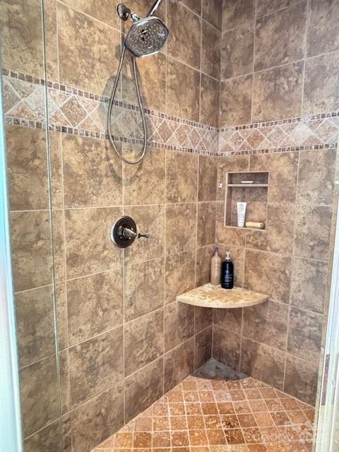 bathroom with a tile shower