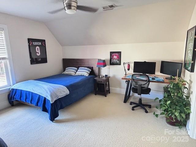 carpeted bedroom featuring vaulted ceiling and ceiling fan